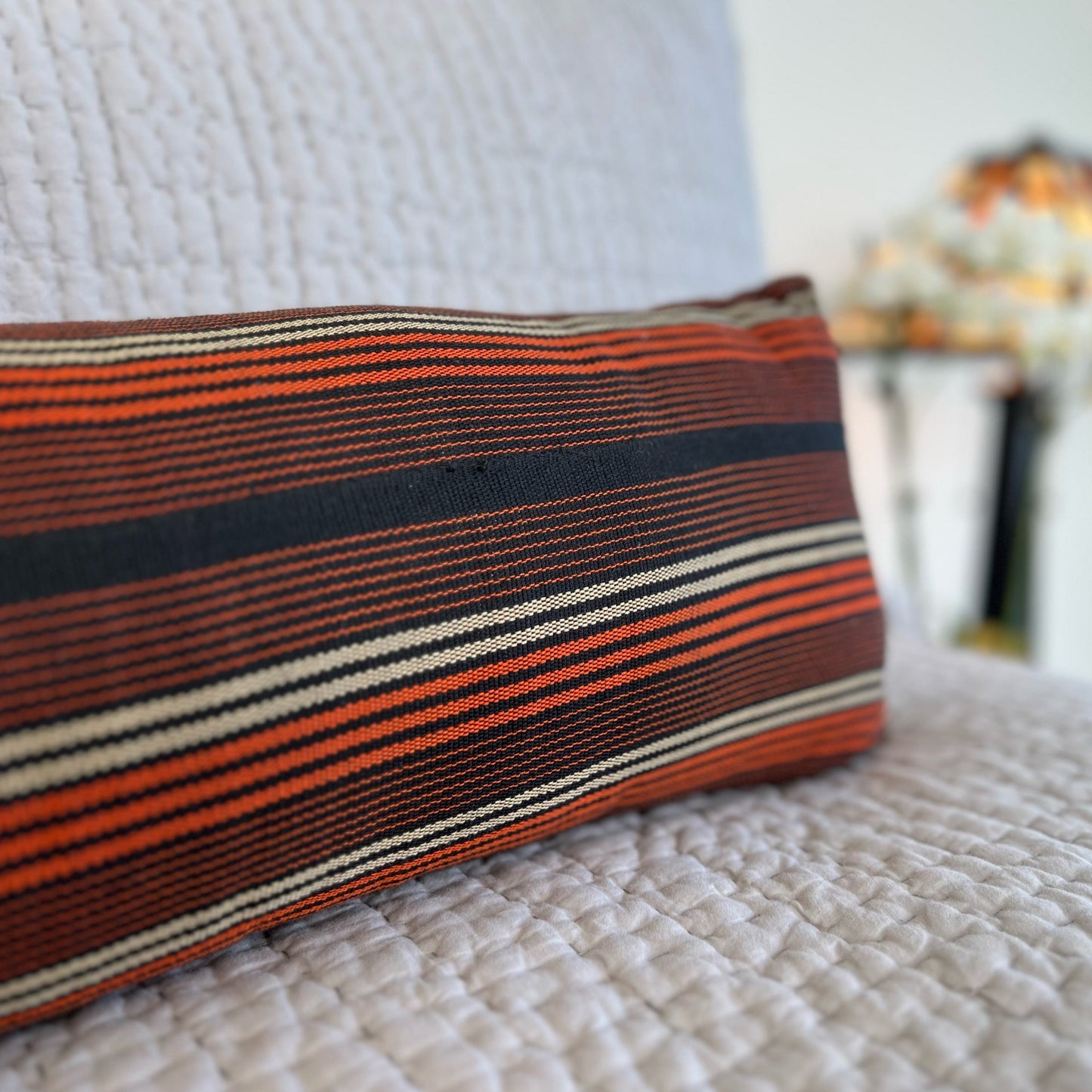 9"x42" bolster pillow cover against white bedding. noraokafor